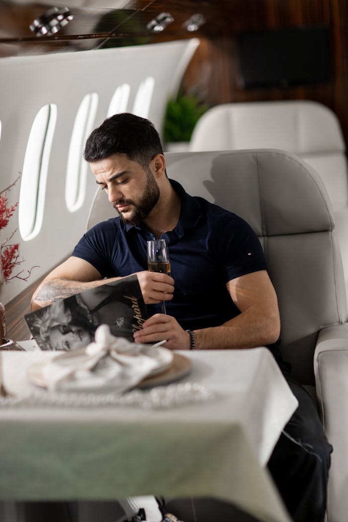 Man Sitting by Table on Airplane